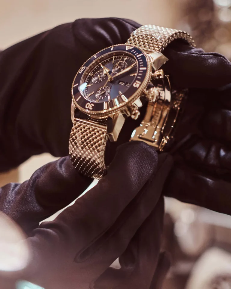 Gloved hand holding a Breitling Superocean Heritage II watch in Orlando