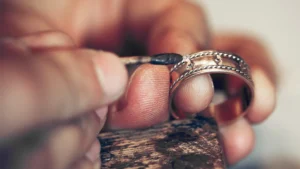 Jeweler working on a gold ring with intricate details in Orlando