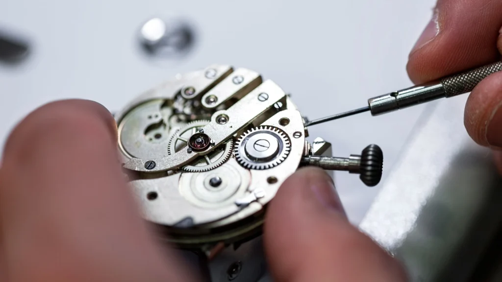 Watchmaker precisely adjusting a mechanical watch movement in Orlando