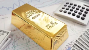 fine gold bar resting on financial charts, with dollar bills and a calculator nearby, symbolizing investment and growth